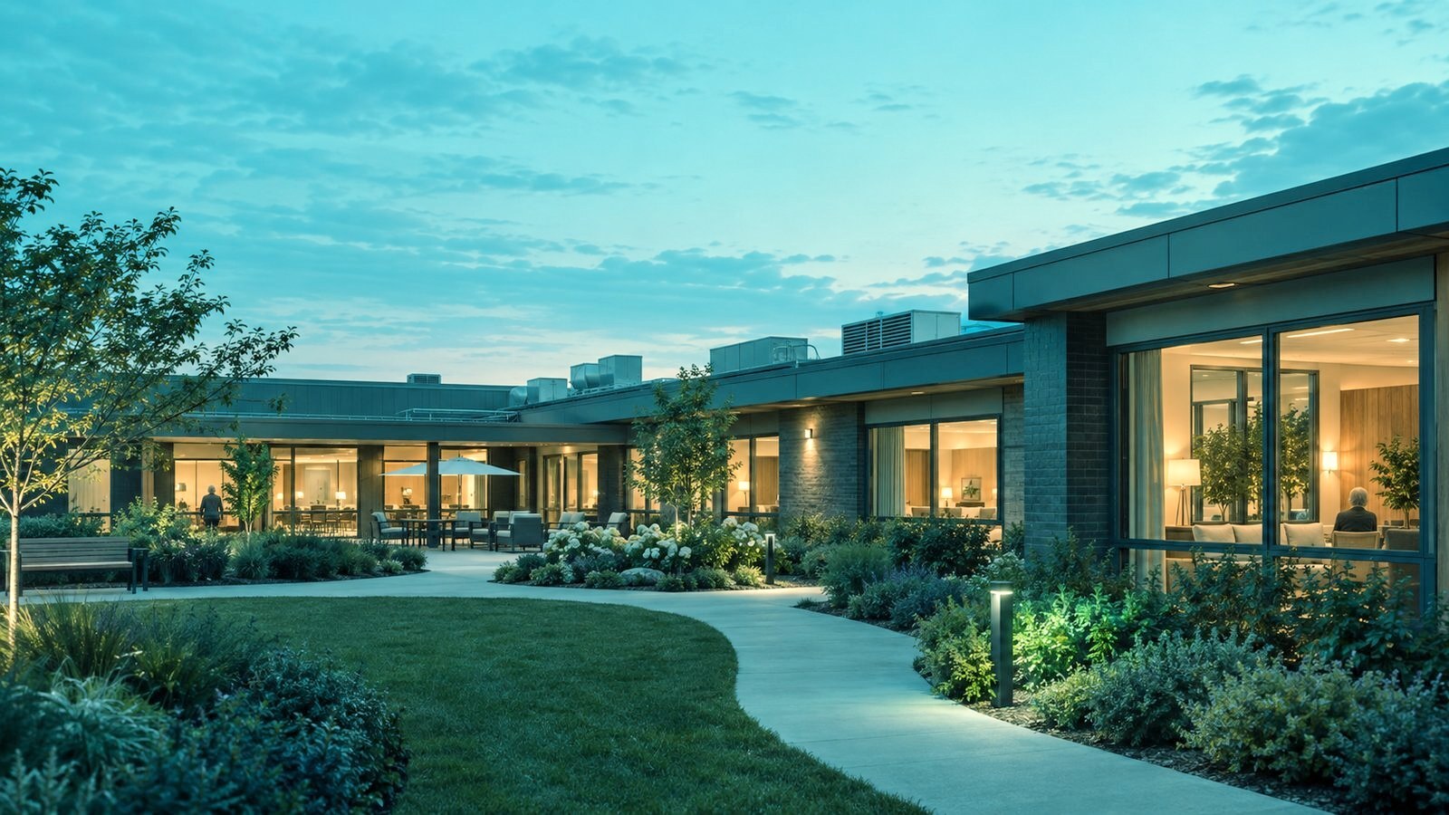 Dementia care residence at evening with a secure landscaped garden