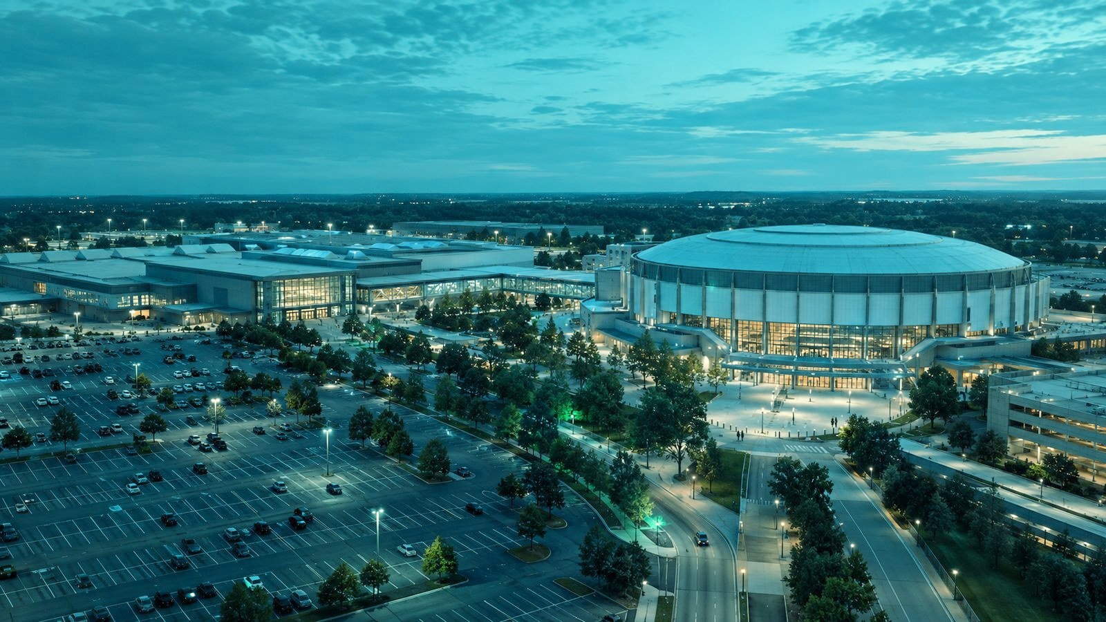 Aerial view of a large events and entertainment campus at blue hour